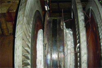 Figure 3. Preheat set-up and side rings/flux retaining plates attached to the parted off disc head